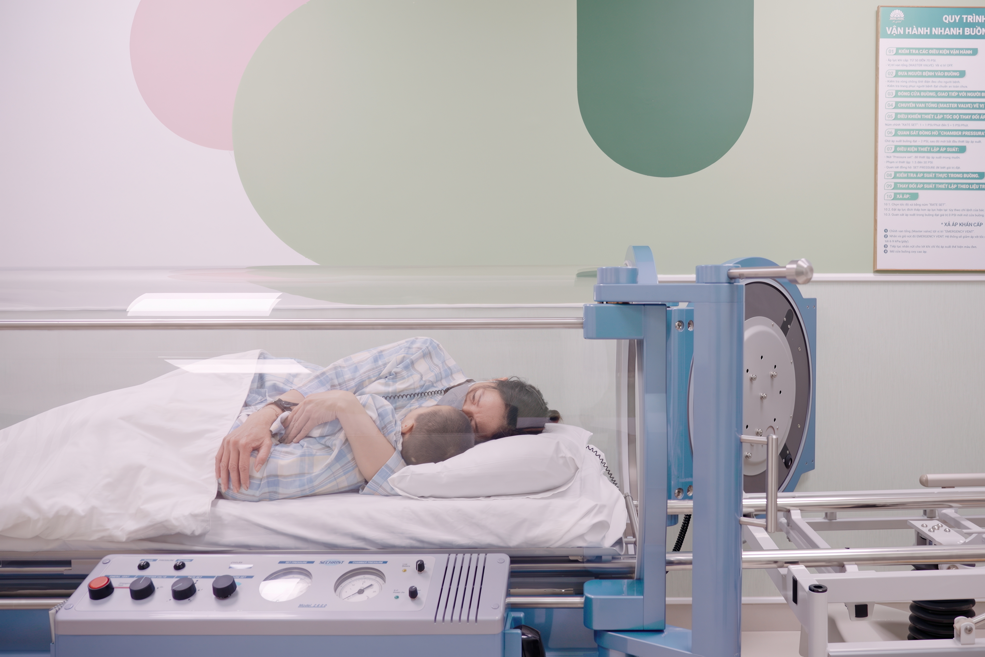 Minh and his grandmother during treatment in a single-patient hyperbaric oxygen chamber.