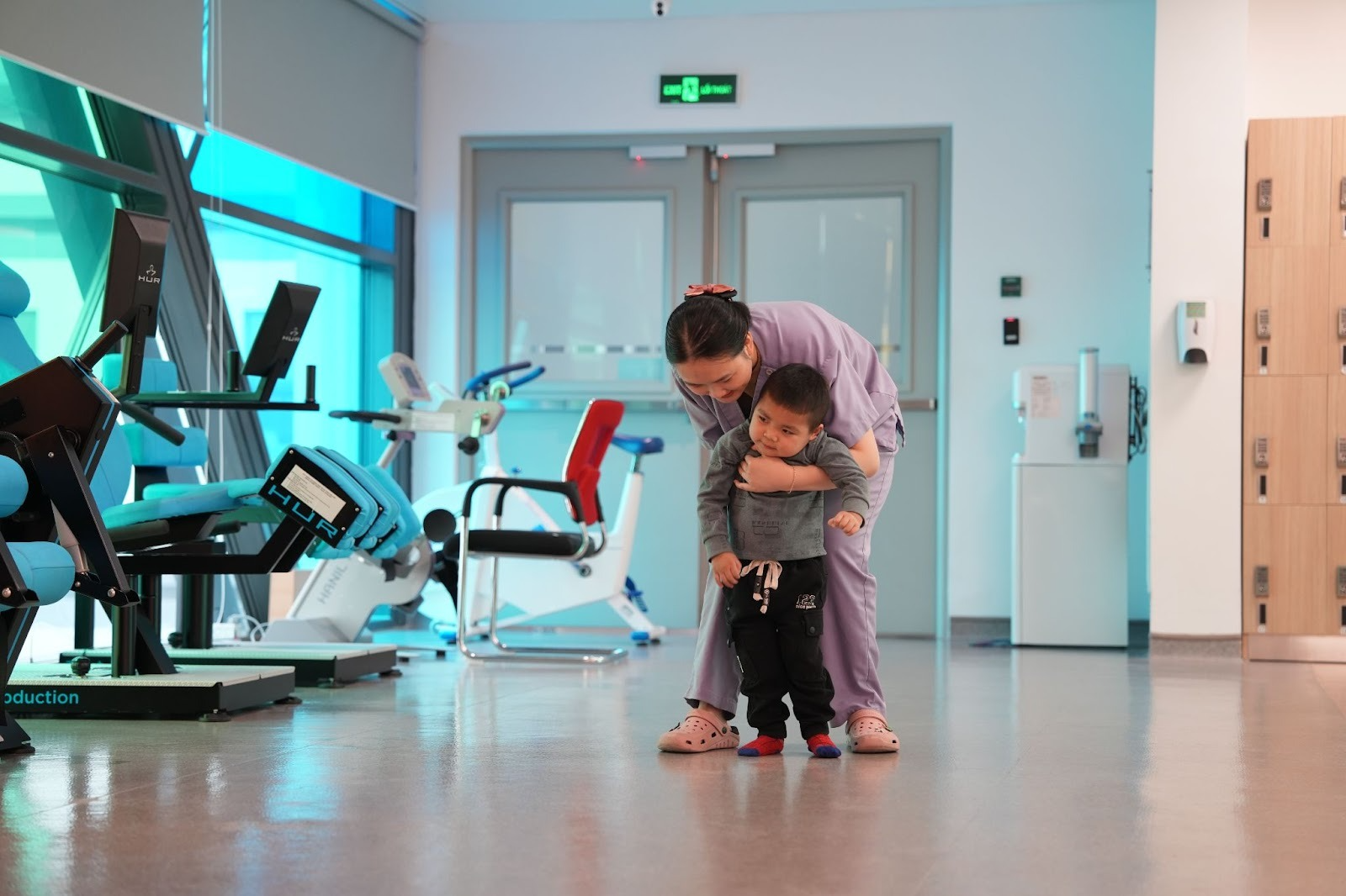 Minh receives rehabilitation training with assistance from a therapist.