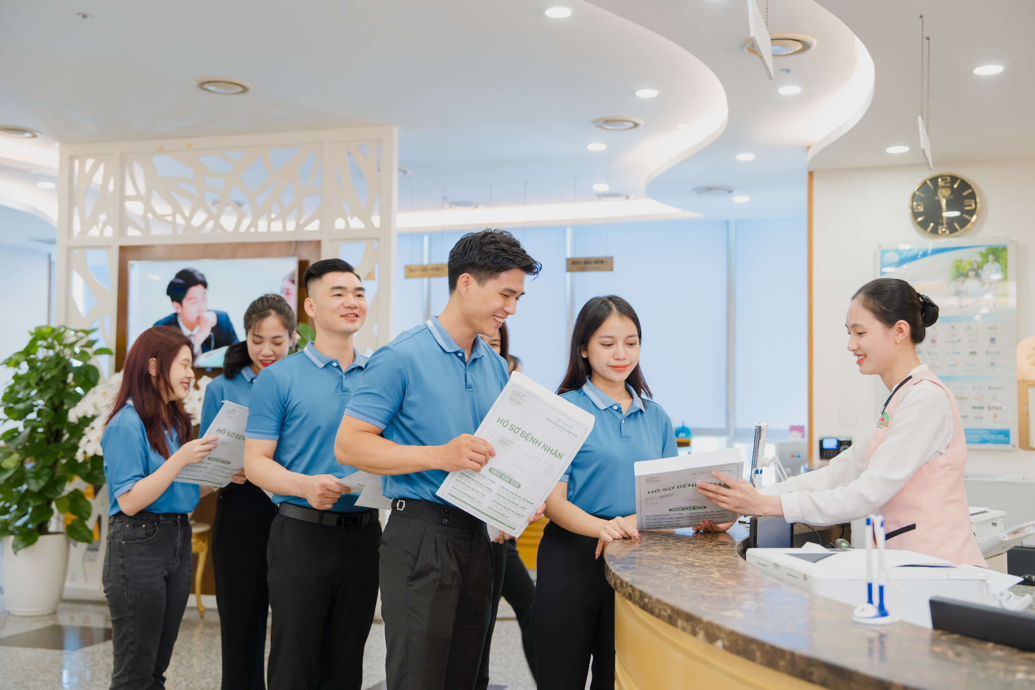 Employees receive their periodic corporate health check-up documents at Hong Ngoc Keangnam General Clinic